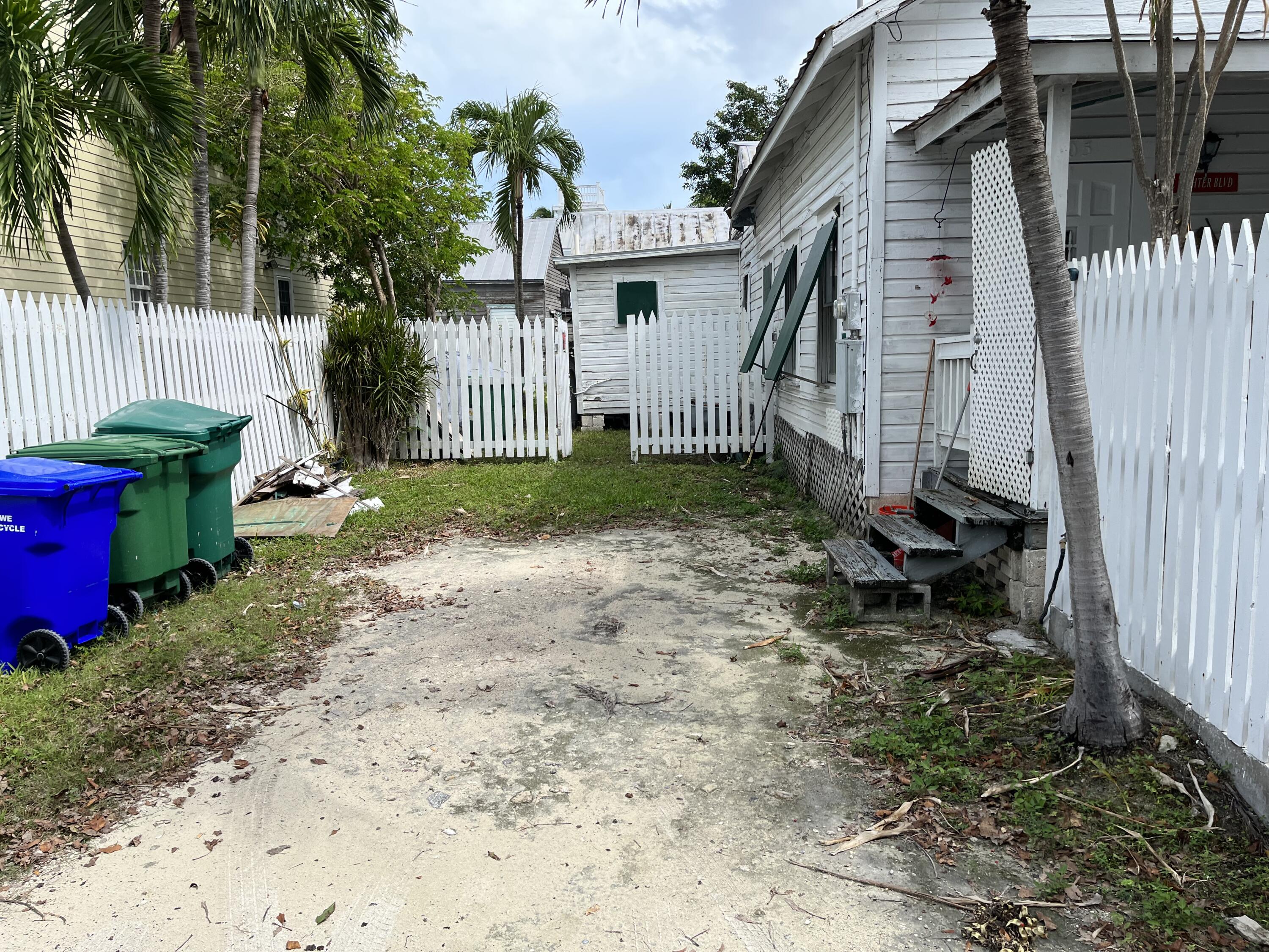 705 Chapman Lane Key West, FL 33040 - Photo 3 of 24 a view of a house with backyard and garden