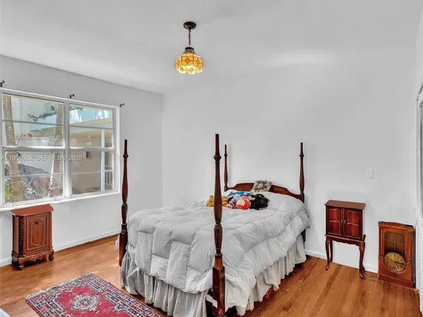 a bedroom with furniture and a flat screen tv