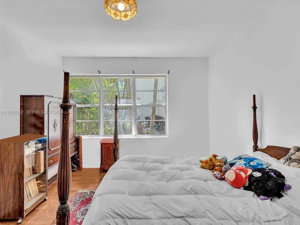 a bed room with a bed furniture and a window