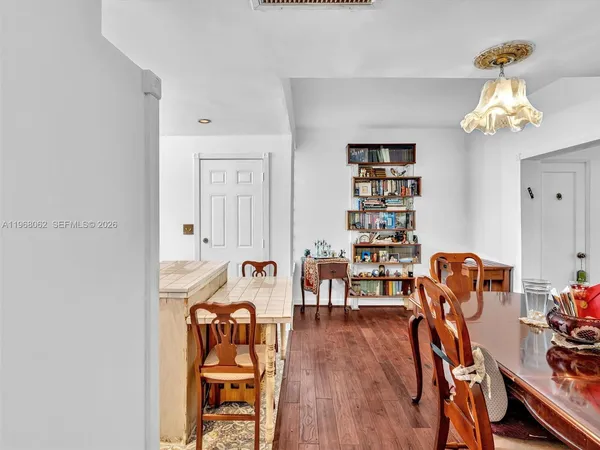 a view of a dining room with furniture and wooden floor
