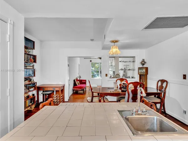 a dining room with furniture a rug and a chandelier
