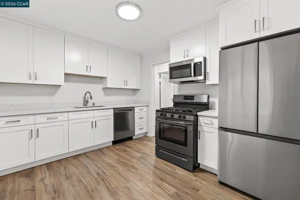 a kitchen with stainless steel appliances a refrigerator sink and stove