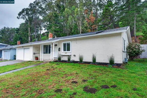 a view of a house with a backyard