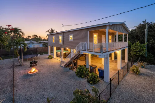 a view of a house with a yard and sitting area