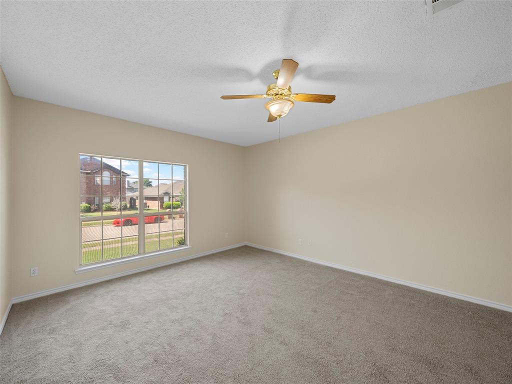 741 Aspen Court Allen, TX 75002 - Photo 22 of 40 Primary bedroom downstairs, featuring fresh paint, carpet, and ceiling fan