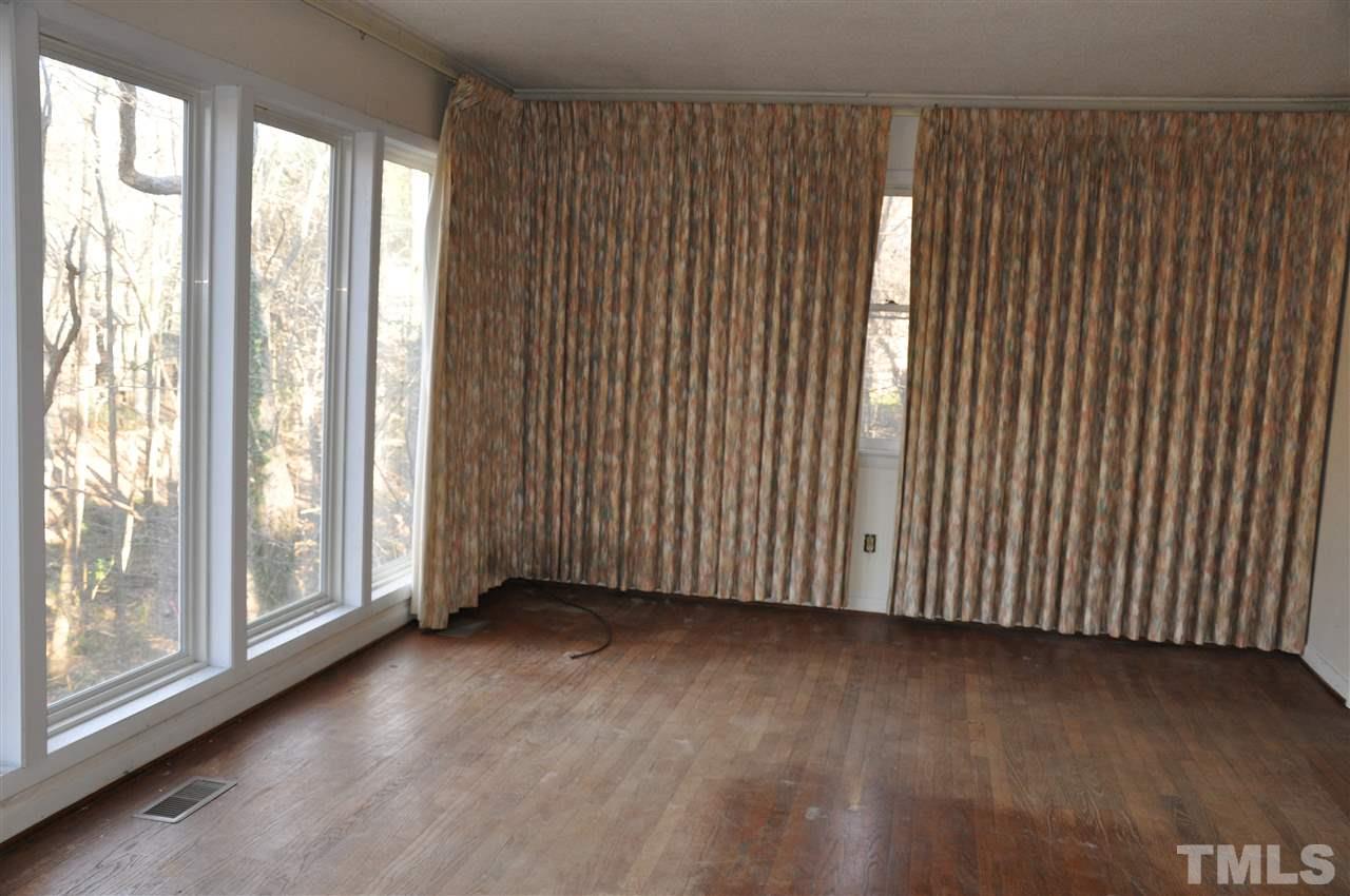 1200 Bancroft Street Raleigh, NC 27612 - Photo 14 of 16 a view of an empty room with wooden floor and a window