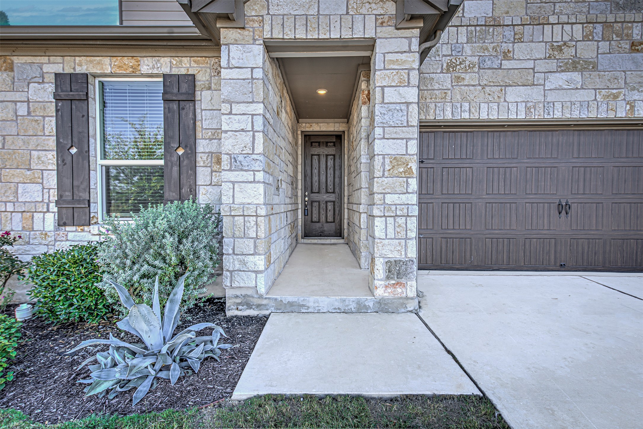 486 Gustaf Trail Kyle, TX 78640 - Photo 2 of 40 a view of a brick house with potted plants