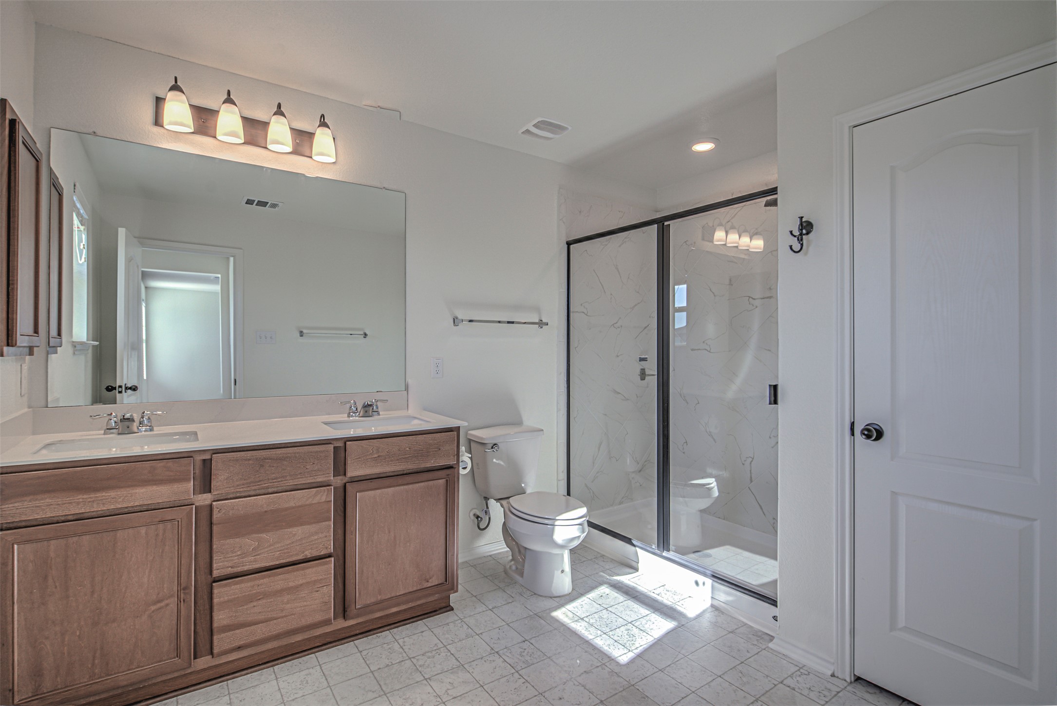 486 Gustaf Trail Kyle, TX 78640 - Photo 30 of 40 a spacious bathroom with a double vanity sink mirror and toilet