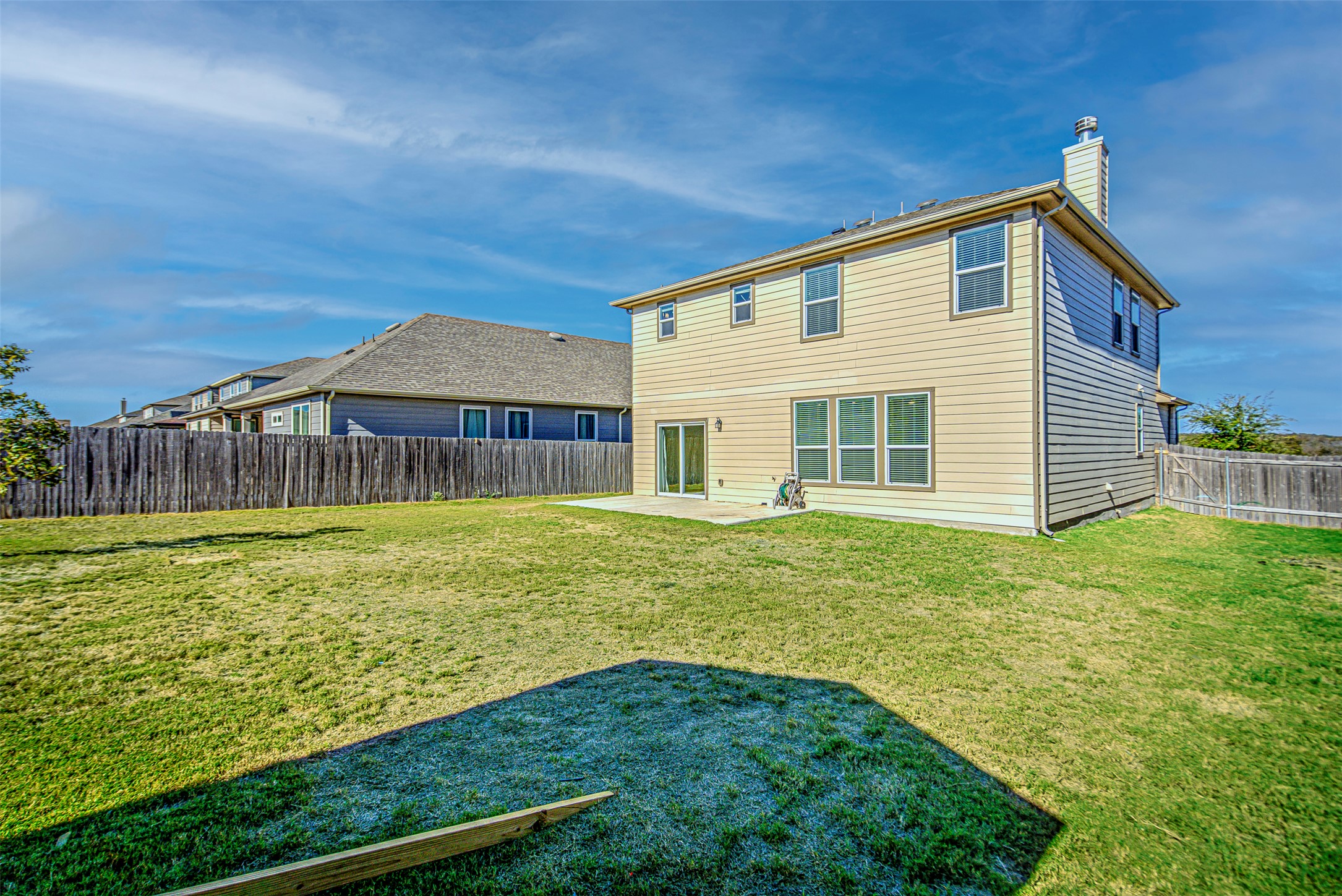 486 Gustaf Trail Kyle, TX 78640 - Photo 32 of 40 a view of a house with backyard and sitting area