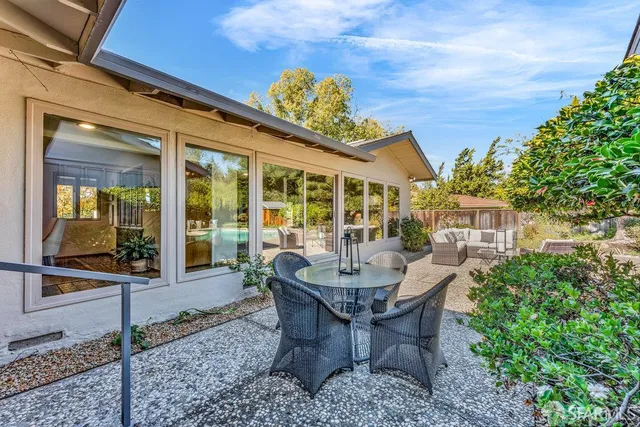 a living room with furniture and view of kitchen