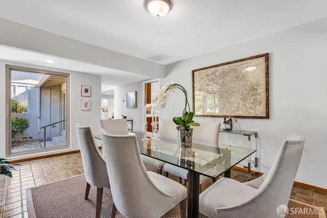 a living room with furniture kitchen view and a window