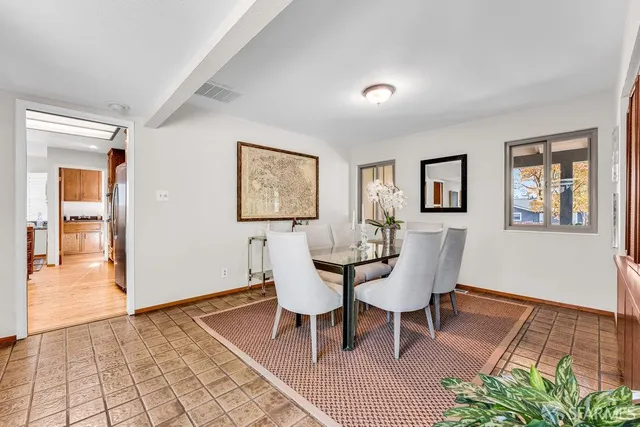 a living room with furniture a large window with kitchen view