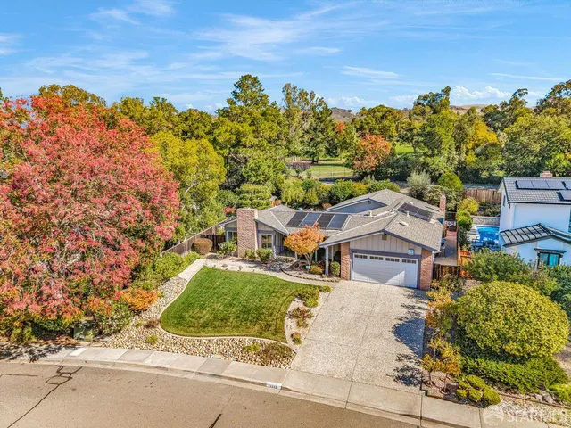 an aerial view of a house with a yard basket ball court and outdoor seating