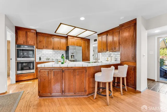 a bedroom with a bed and painting on the wall