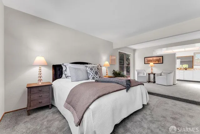 a view of a patio with couches and a table and chairs with plants and trees