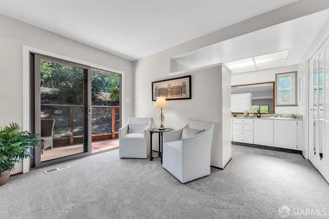 a backyard of a house with barbeque oven and trees