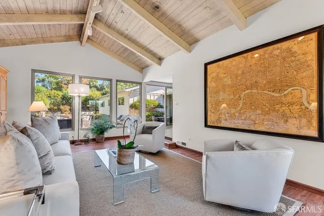 a view of a house with swimming pool and sitting area