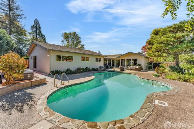 a view of a swimming pool with a patio