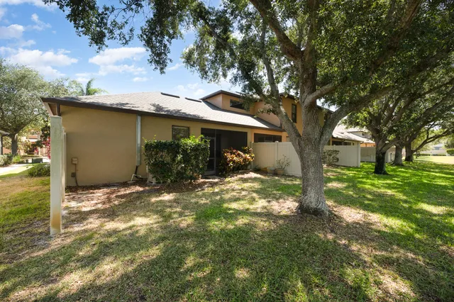 a backyard of a house with table and chairs