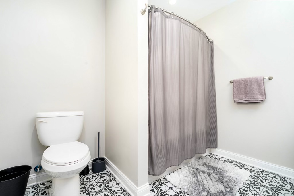 2235 West Acres Road Joliet, IL 60435 - Photo 16 of 26 a bathroom with a toilet and shower