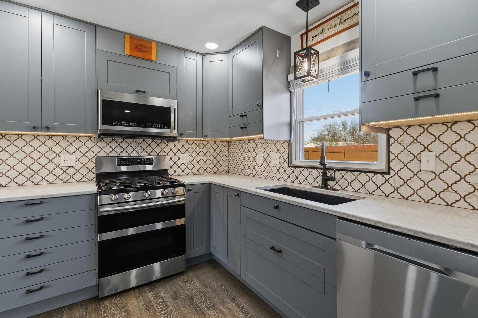 11622 27th Street West Milan, IL 61264 - Photo 4 of 49 a kitchen with granite countertop a sink stove and microwave
