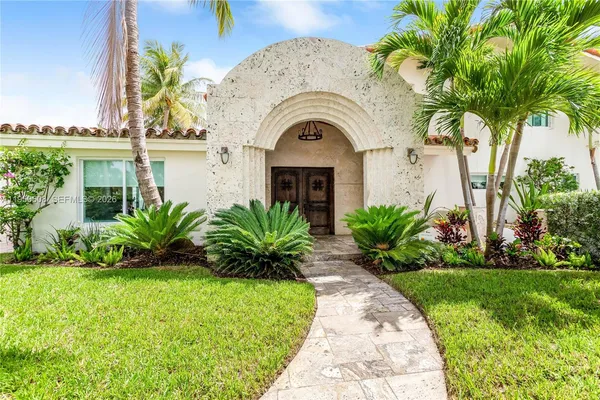 a front view of a house with a garden