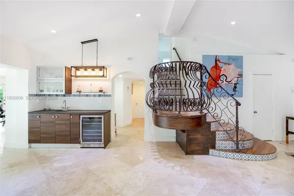 a view of a kitchen with stainless steel appliances granite countertop a stove and a sink