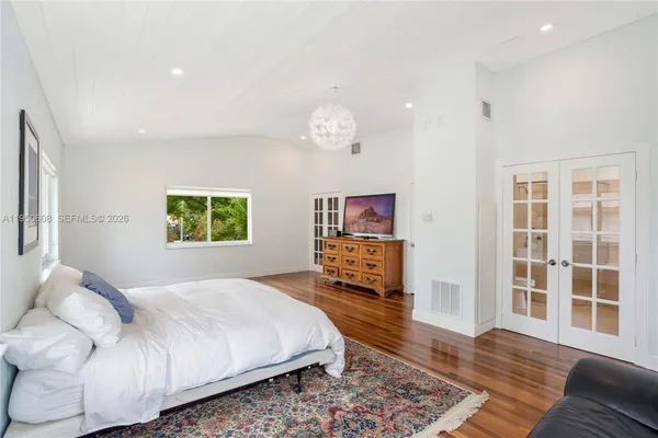 a spacious bedroom with a bed couch and a window