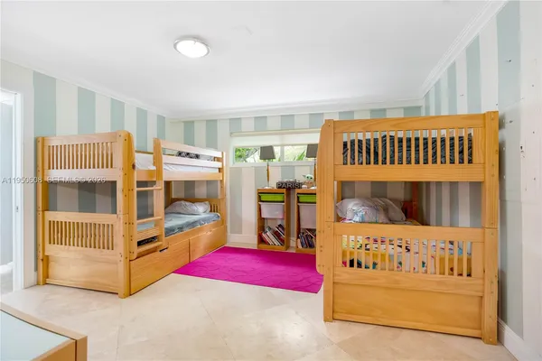 a bedroom with furniture and a large window