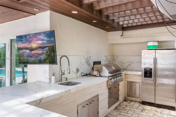 a kitchen with kitchen island a sink stainless steel appliances and counter space