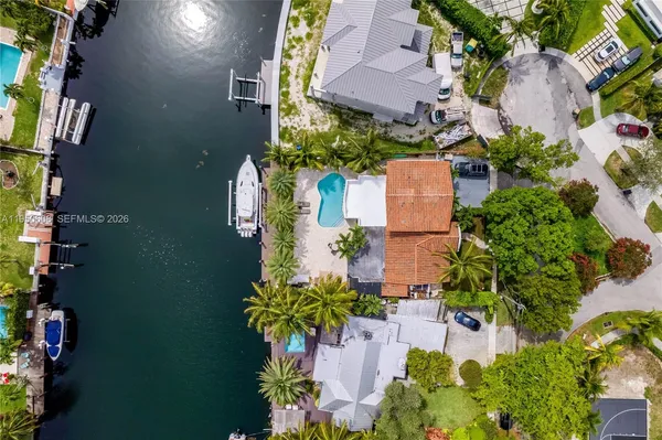 an aerial view of a house with a yard and garden