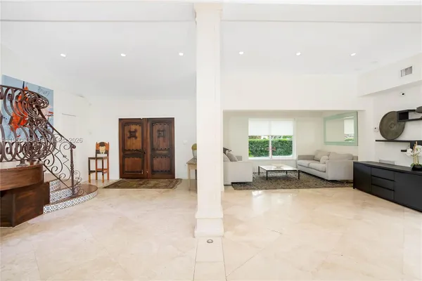 a view of living room filled with furniture and a flat screen tv