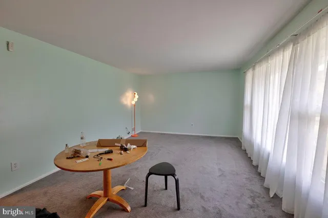 a brick house with a big yard and large trees