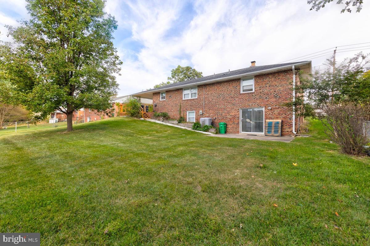 4305 Briggs Chaney Road Beltsville, MD 20705 - Photo 18 of 26 a brick house with a big yard and large trees