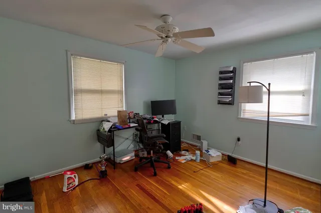 a view of a workspace with furniture and a window