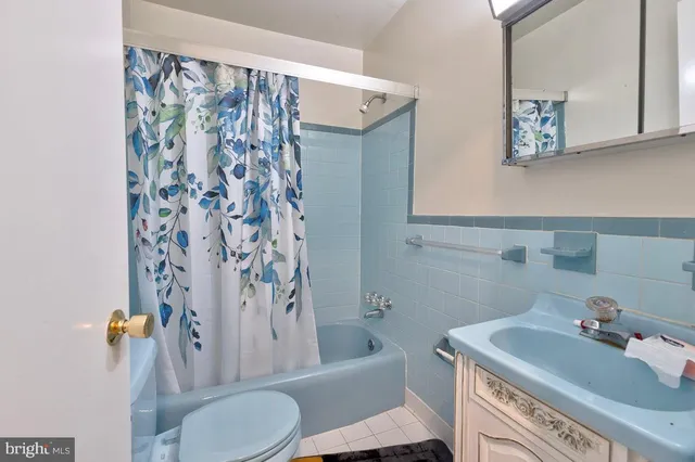 a room with stainless steel appliances kitchen island granite countertop a refrigerator and microwave