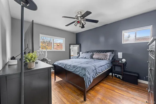 a bedroom with a bed and ceiling fan