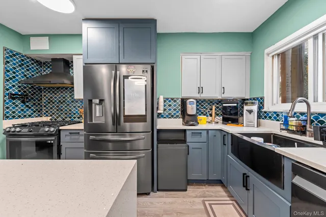 a kitchen with appliances a sink and cabinets