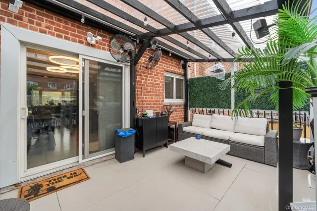 a building outdoor space with patio furniture and potted plants