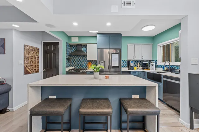 a kitchen with counter and chairs