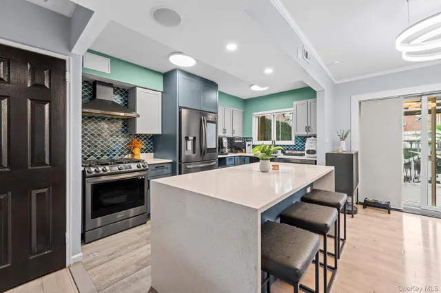 a kitchen with a sink stainless steel appliances and white cabinets