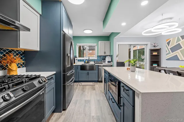 a kitchen with stainless steel appliances granite countertop a stove and a sink