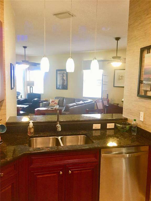 17084 Acapulco Road, Unit 223 Punta Gorda, FL 33955 - Photo 4 of 21 a bathroom with a granite countertop sink and a mirror