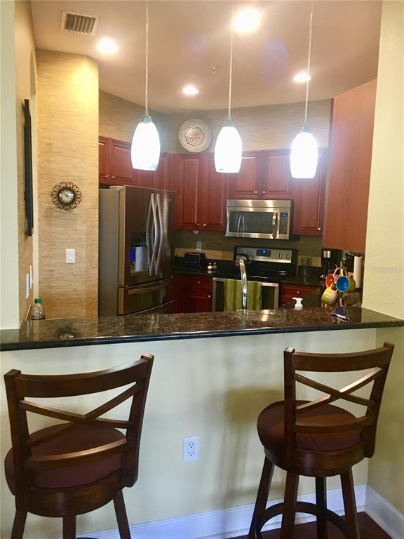 17084 Acapulco Road, Unit 223 Punta Gorda, FL 33955 - Photo 5 of 21 a large kitchen with a table and chairs in it