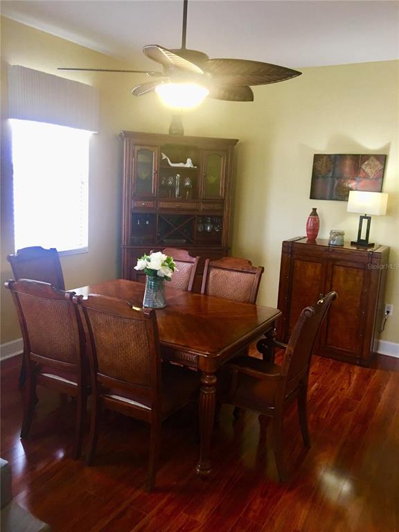 17084 Acapulco Road, Unit 223 Punta Gorda, FL 33955 - Photo 7 of 21 a view of a dining room with furniture and wooden floor