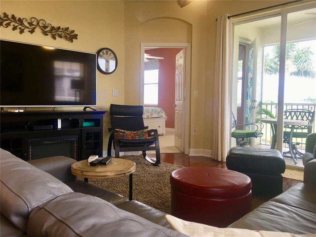 17084 Acapulco Road, Unit 223 Punta Gorda, FL 33955 - Photo 8 of 21 a living room with furniture a large window and a flat screen tv