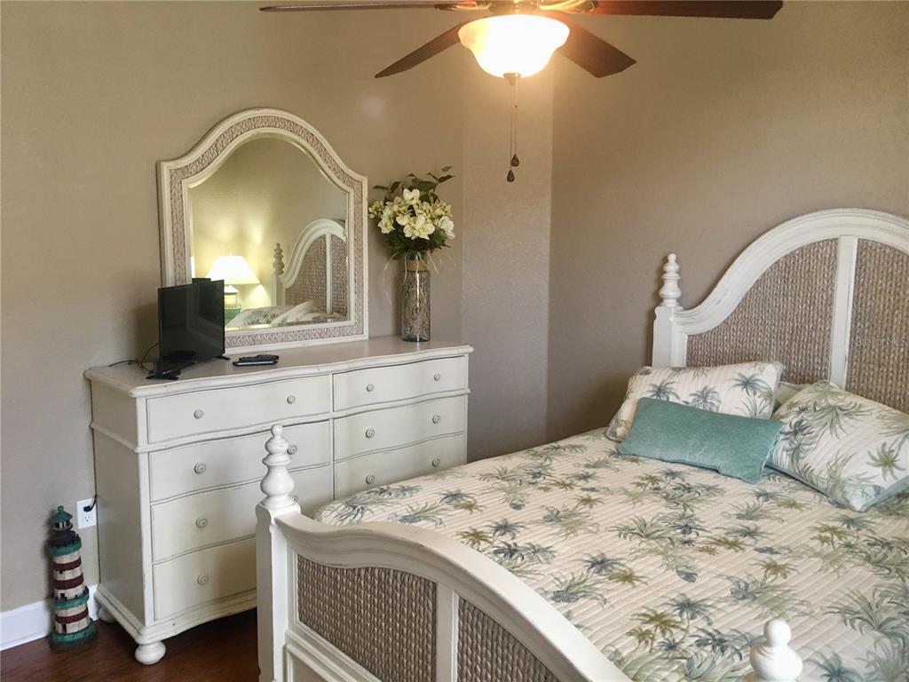 17084 Acapulco Road, Unit 223 Punta Gorda, FL 33955 - Photo 10 of 21 a bedroom with a bed and a mirror on dresser