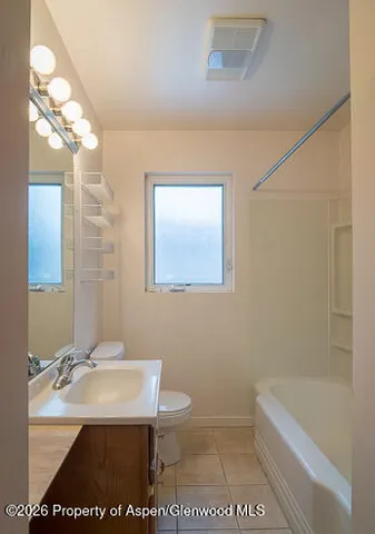 a bathroom with a sink a toilet and a bathtub