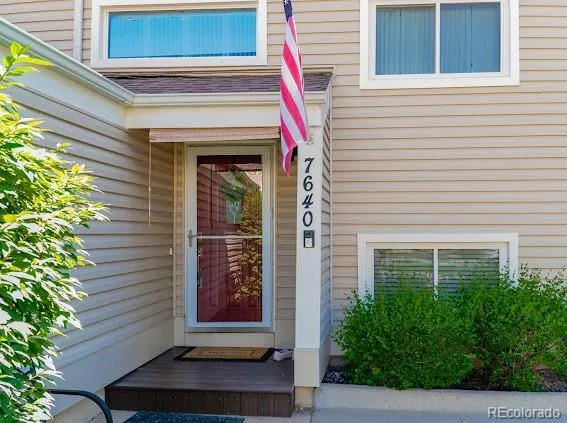 a front view of a house with plants