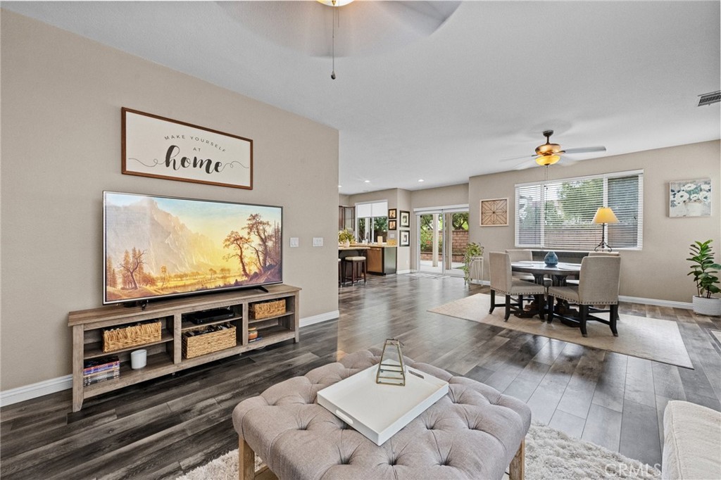 7220 Cumberland Place Rancho Cucamonga, CA 91739 - Photo 20 of 41 Comfortable part of the Great Room with plush seating, a ceiling fan, and an open view to the kitchen.